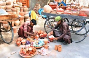 Workers busy coloring clay-made pots